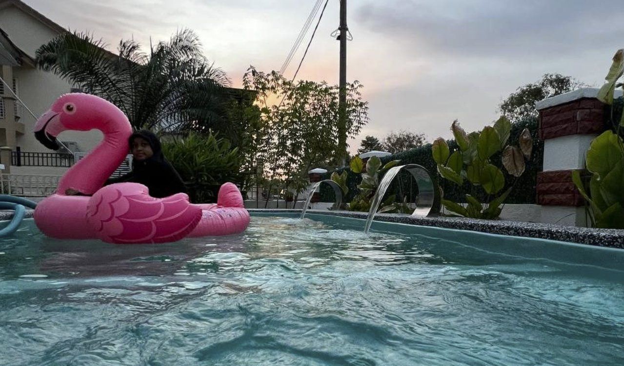 Sunset swim in the private pool with flamingo float and waterfall features